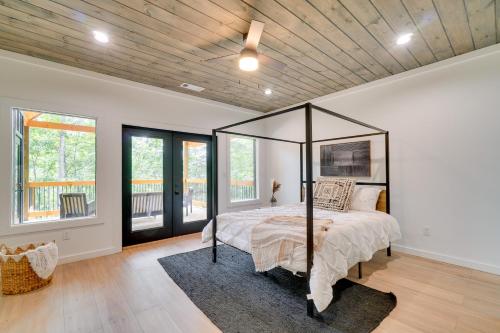 a bedroom with a bed with a canopy at Luxe Sevierville Home with Deck Near Pigeon Forge! in Sevierville