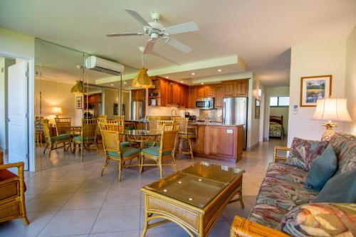 a living room with a couch and a table at Papakea J202 in Kahana