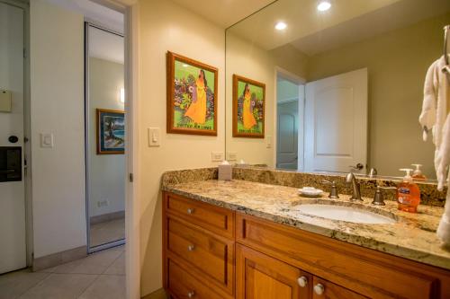 a bathroom with a sink and a mirror at Papakea J202 in Kahana
