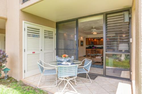 a patio with a table and chairs on a porch at Kamaole Sands 2-106 in Wailea