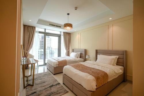 a hotel room with two beds and a window at Luxury Apartment burj khalifa view in Dubai
