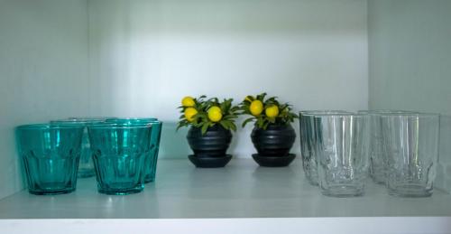 a group of blue glass cups sitting on a shelf at Safty Palm Oasis Private Pool & Beach Access in Ain Sokhna