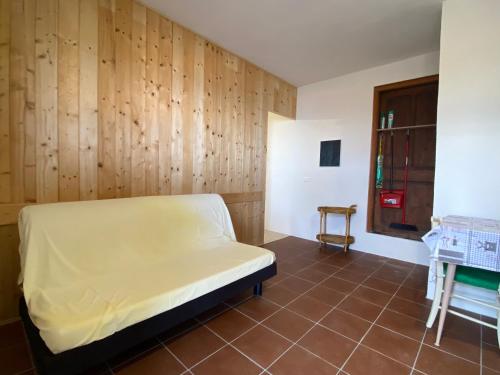 a bedroom with a bed and a wooden wall at Ca' Nostra in Ventimiglia