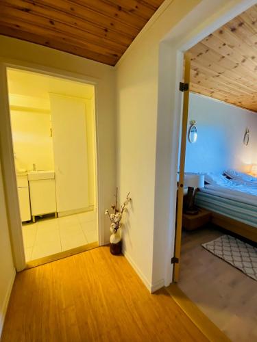 a room with a bed and a door to a bedroom at Brunns Lake House in Ulricehamn