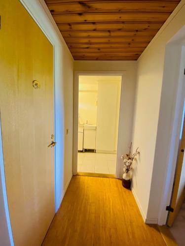 an empty room with a hallway with a door at Brunns Lake House in Ulricehamn