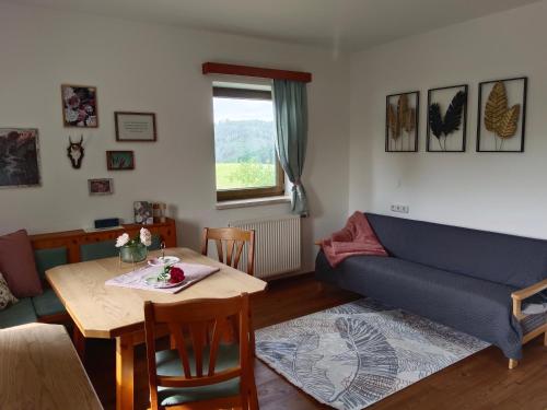 a living room with a couch and a table at Ferienwohnungen Aumayr in Gutau