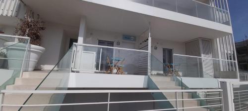 a balcony of a building with two chairs on it at Biancaluna in Polignano a Mare