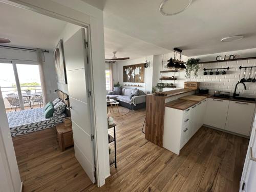an open kitchen and living room with a couch at Sunsetmare Vacational Apartment in Roses