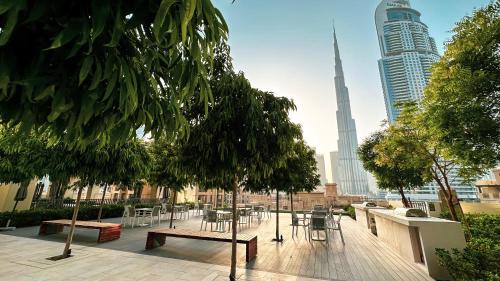 a patio with tables and chairs in a city at SmartStay at Burj Royale - Full Burj Khalifa View - Brand New Luxury Apartments in Dubai