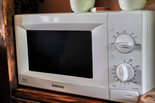 a white microwave sitting on top of a table at EcoXata in Slavske