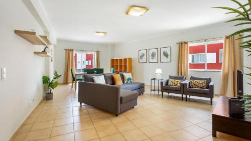 a living room with a couch and two chairs at Villas Boas House Silves in Silves