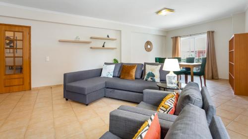 a living room with a couch and a table at Villas Boas House Silves in Silves