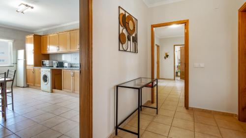 a kitchen and dining room with a glass table at Villas Boas House Silves in Silves