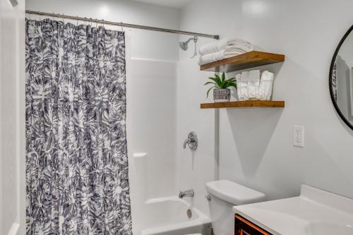a bathroom with a shower curtain and a toilet at Sleek San Fernando Studio about 14 Mi to Universal in San Fernando