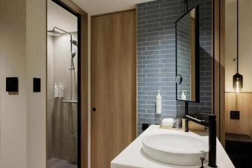 a bathroom with a sink and a shower at Fairfield by Marriott Hyogo Awaji Higashiura in Awaji
