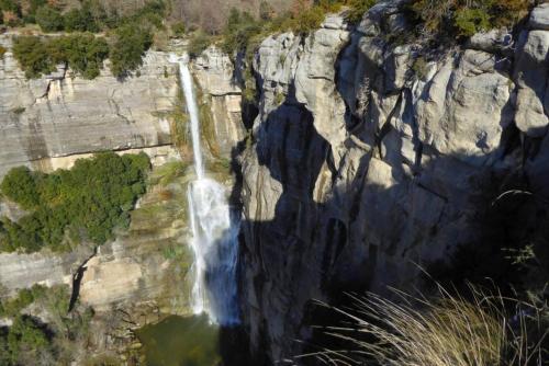 an aerial view of a waterfall on a cliff at Can Vila Rupit in Rupit