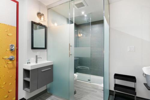 a bathroom with a glass shower and a sink at Inn 15 Brewery Loft Suites in Kingsville