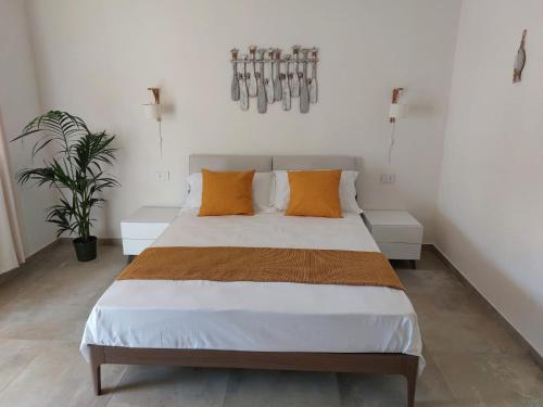 a bedroom with a large bed with orange pillows at Le Barche Volanti in Lampedusa