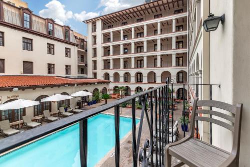 a balcony of a hotel with a swimming pool and buildings at Omni La Mansion del Rio in San Antonio