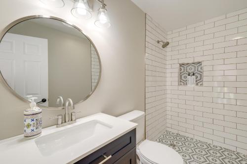 a white bathroom with a sink and a mirror at Beautiful Bellaire Home with Amenities, 4 Mi to Lake in Bellaire