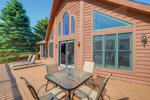 a patio with a glass table and chairs on a deck at Beautiful Bellaire Home with Amenities, 4 Mi to Lake in Bellaire