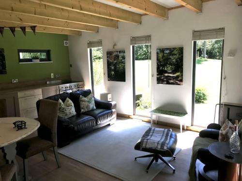 a living room with a couch and a table at Log cabin rural retreat in beautiful countryside in Lapworth
