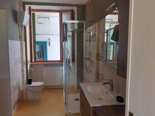 a bathroom with a shower and a sink and a toilet at Tuscany, Pontremoli, Italy Swallows Court Lovely home sleeps 2 to 4 people in Pontremoli