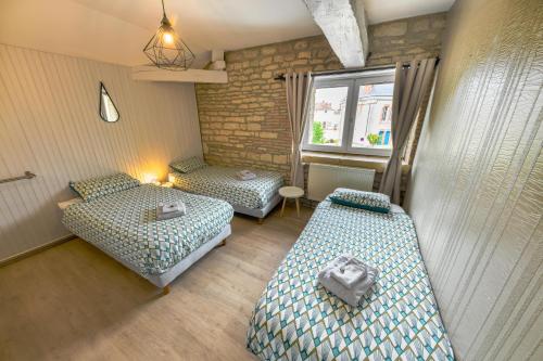 a room with two beds and a window at Domaine le Colombier in Dienville