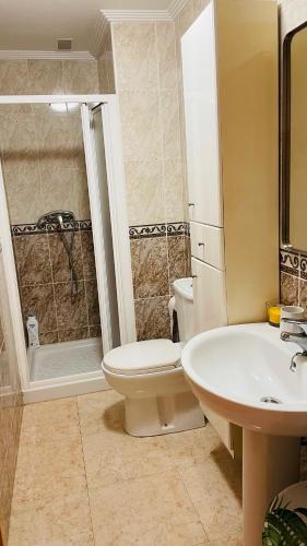 a bathroom with a white toilet and a sink at Holiday with a sea view in Torrevieja