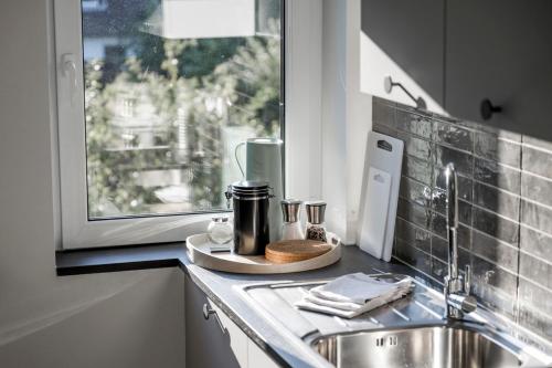 a kitchen counter with a sink and a window at Hohwaii Waikiki in Hohwacht