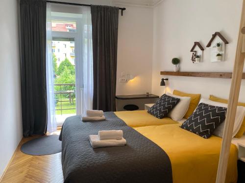 a bedroom with two beds with towels on them at Boennium Apartments Green Oasis in Ljubljana