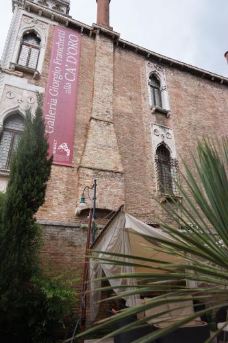 a building with a sign on the side of it at Pesaro Palace in Venice