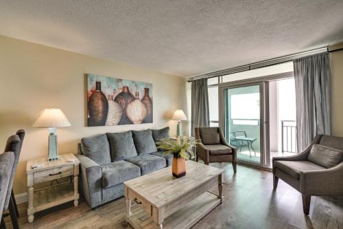 a living room with a couch and a table at Oceanfront Myrtle Beach Condo with Pools and Hot Tubs in Myrtle Beach