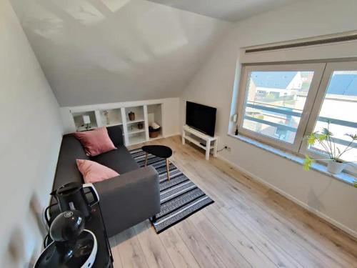 uma sala de estar com um sofá e uma televisão em Bel-etage Bruges Homestay - Free parking - Entire floor em Bruges