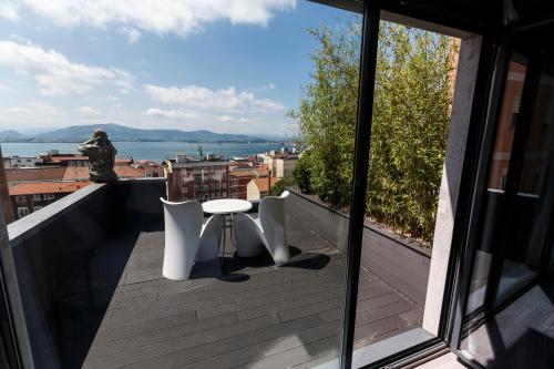 a balcony with a table and chairs and a view at Hotel Art Santander in Santander