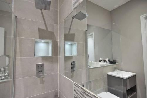 a bathroom with a shower and a sink at Sea View I High Ceiling I Next to Brighton Beach in Brighton & Hove