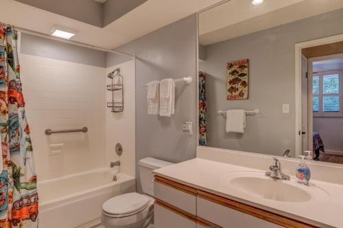 a bathroom with a sink and a toilet and a shower at Kanai A Nalu 210 in Wailuku