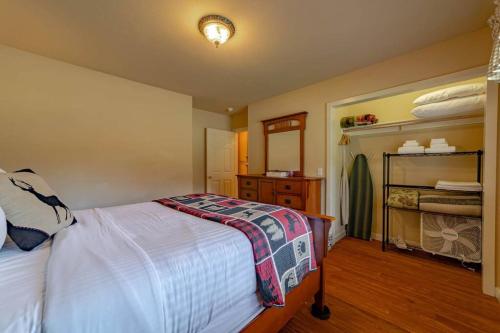 a bedroom with a bed and a dresser in it at Elk Meadow Cabins 13A Bears Den Suite in Orick
