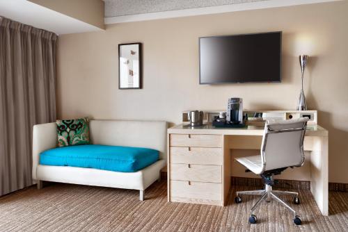 a hotel room with a desk and a chair at Atrium Hotel Orange County in Irvine