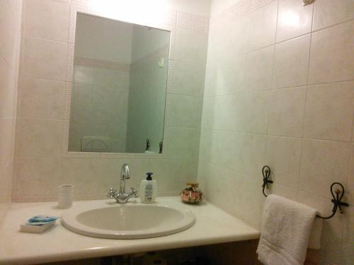 a bathroom with a sink and a mirror at B&B da Anna in Bosa