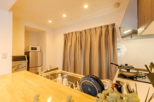 a kitchen with a counter and a stove top oven at 駒込駅徒歩7分/旧古河庭園至近(100m)の4LDKマンション「92m2」 in Tokyo