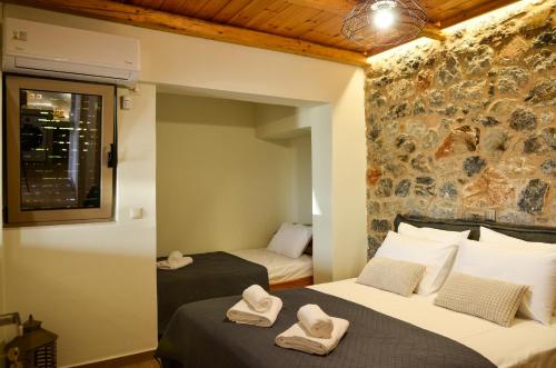 a bedroom with two beds with towels on them at Verga Paradise Nest - A Blissful Hideout in Almirón