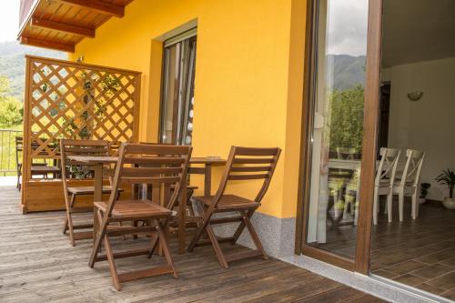 a wooden table and chairs on a deck at Apartments Maligoj in Tolmin