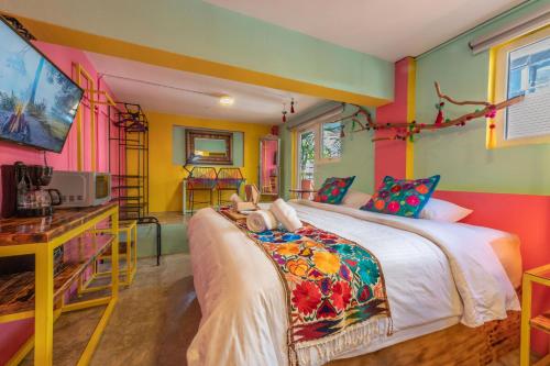 1 dormitorio con 1 cama con paredes coloridas en Casa Colibrí Malecón, en Puerto Vallarta