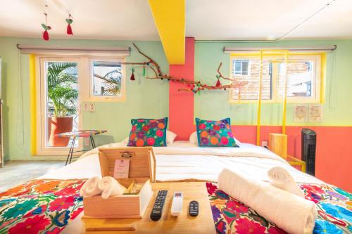a bedroom with a bed and a table with towels at Casa Colibrí Malecón in Puerto Vallarta
