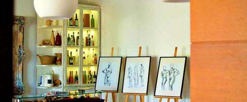 a group of drawings on a wall in a room at Monte Do Malhao - Art, Eco & Spa in Castro Marim