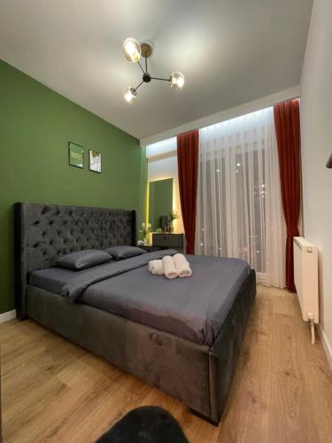 a bedroom with a bed with two towels on it at DAF apartaments in Pristina