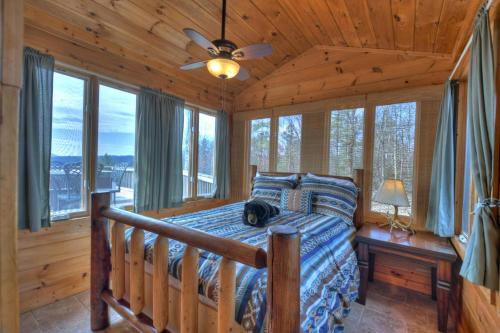 um quarto com uma cama num chalé de madeira em Lazy Bear Outlook em Ellijay