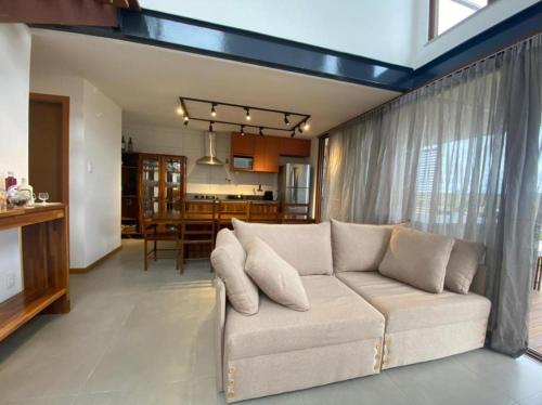 穆庫熱的住宿－Vila beija-flor prime / apt 02，带沙发的客厅和用餐室
