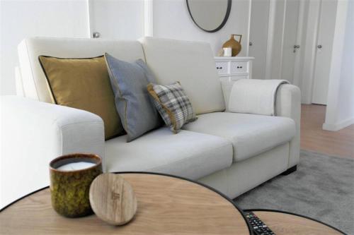 a living room with a white couch and a table at Boavista 19 in Braga
